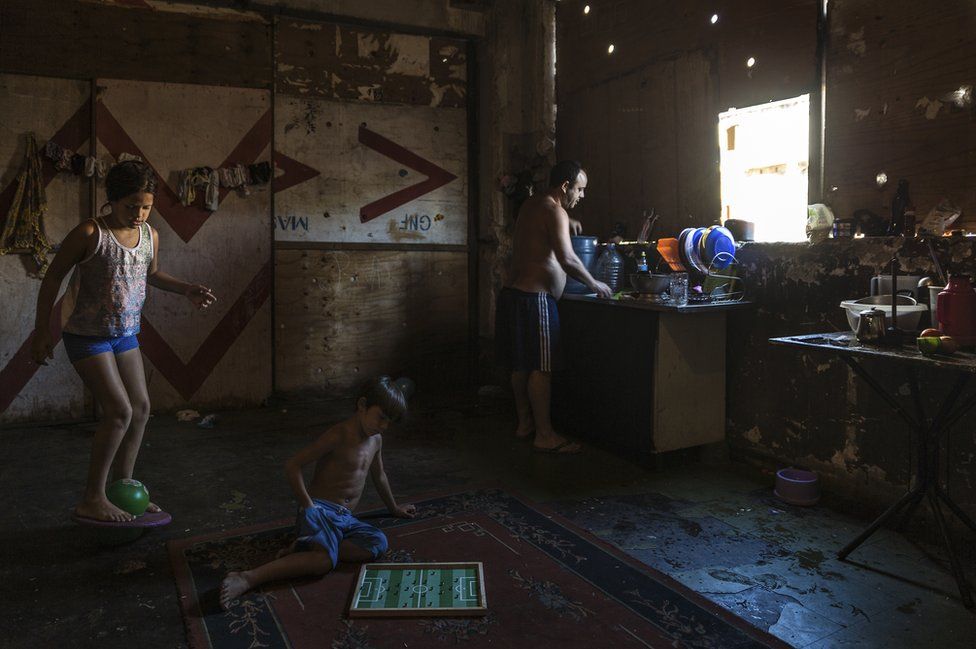 A young family, residents of the abandoned IBGE building - an occupied squat. 'Favela' Mangueira community, Rio de Janeiro, Brazil
