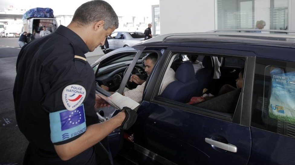 Frontex guard checks passport, file pic