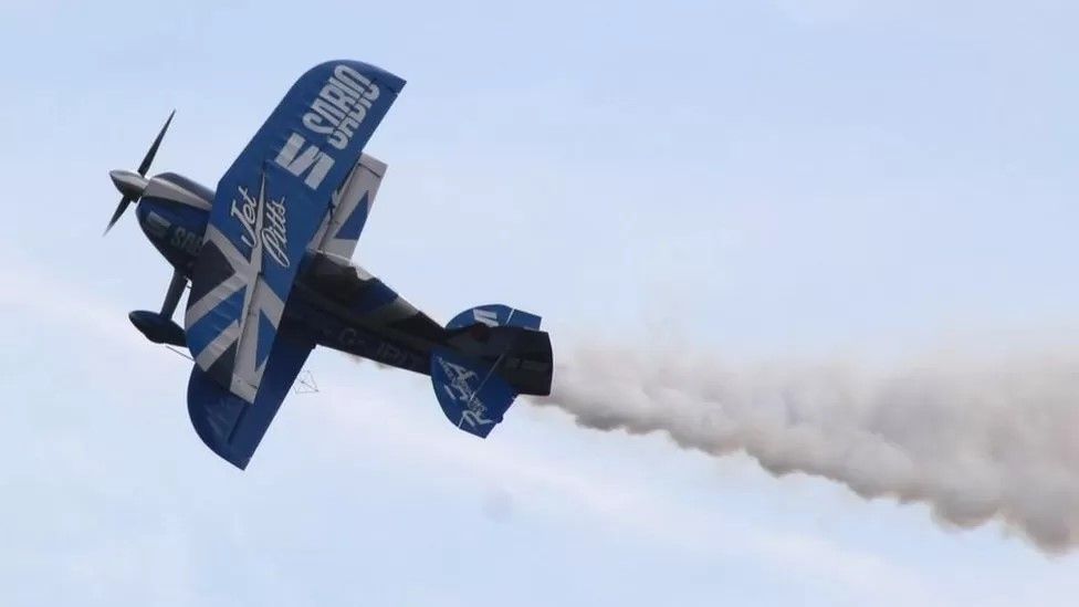 Blue and white Pitts biplane