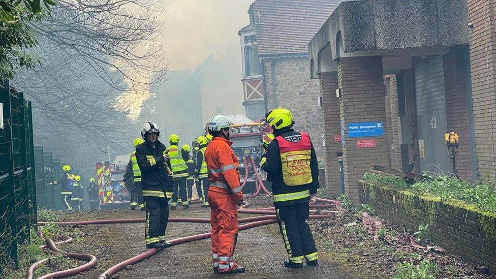 Firefighters at the scene of a burning derelict building