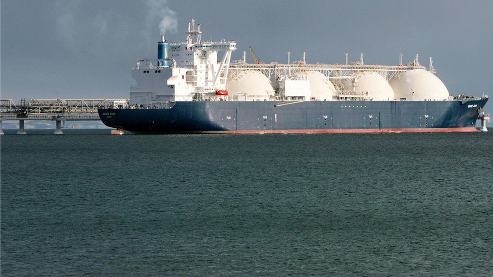 A liquefied natural gas tanker sits near a liquefied natural gas plant in Russia