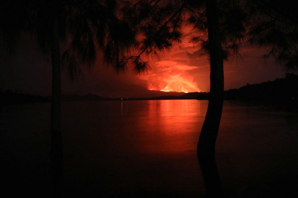 This general view taken on 22 May 2021 from Tchegera Island outside Goma on the lake Kivu in the East of the Democratic Republic of Congo shows flame spewing from the Nyiragongo volcano.