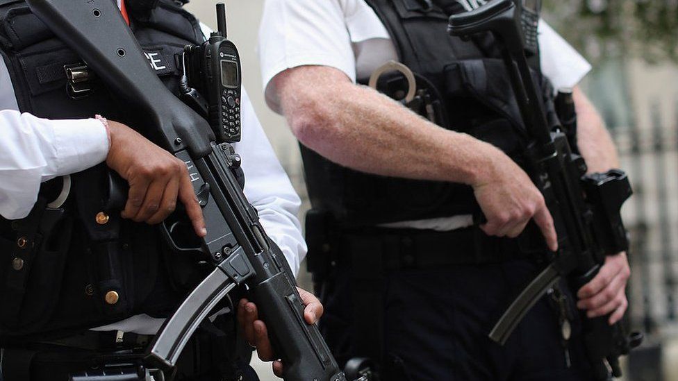 Armed police officers stand in Downing Street