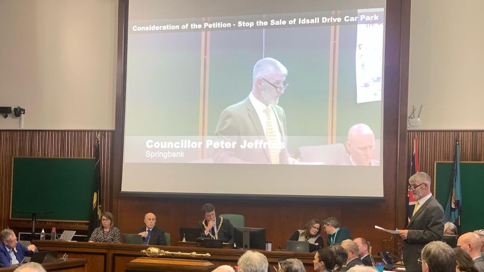 Cllr Peter Jeffries speaking at The Municipal Offices in Cheltenham, seen on a big screen
