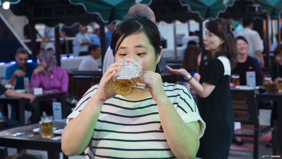 A woman drinking beer, North Korea
