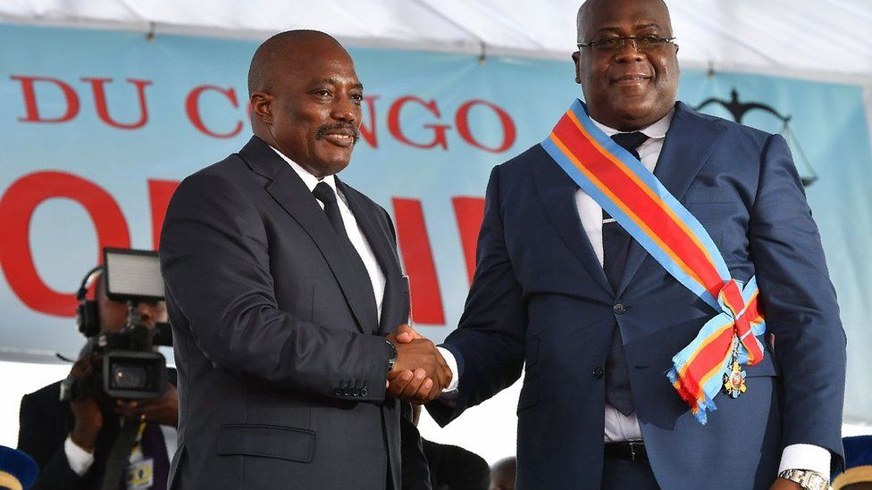 Joseph Kabila shakes hands with Felix Tshisekedi