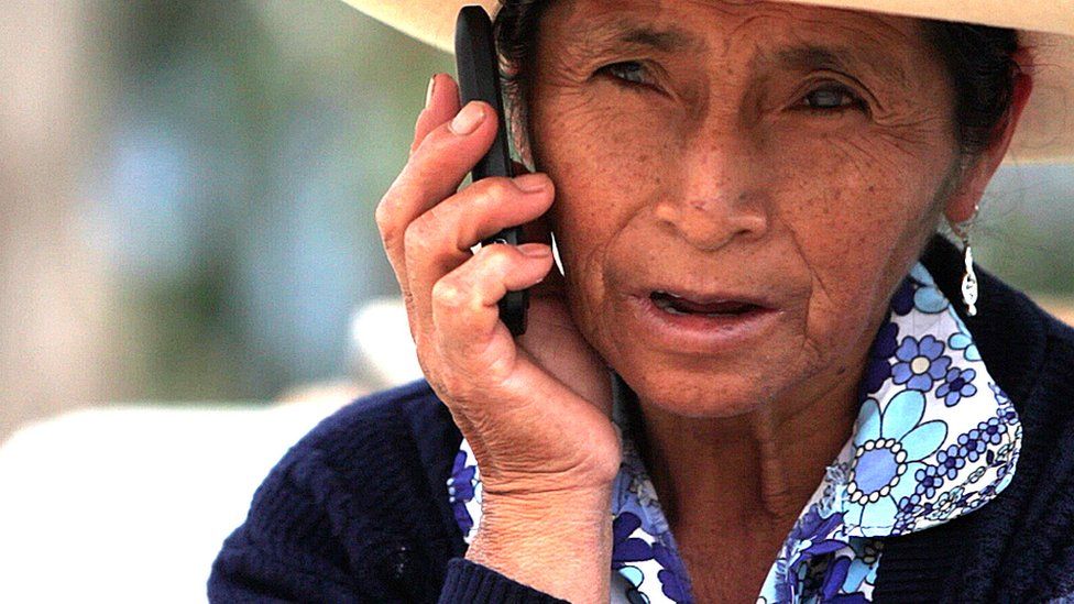 A Peruvian woman talking on a mobile phone
