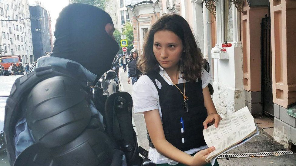 Olga showing constitution to a policeman