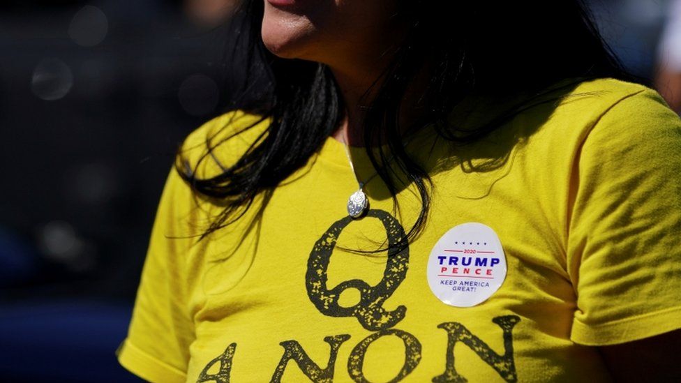 A supporter of US President Donald Trump wears a QAnon shirt
