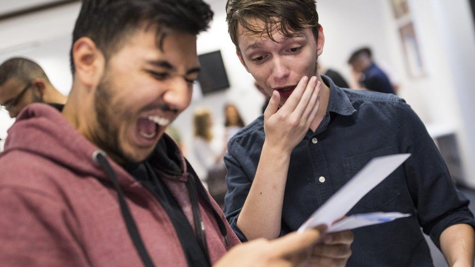 Two male student getting their A level results