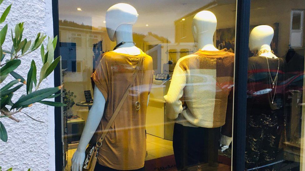 Boutique Maya Maya with mannequins with backs turned to window