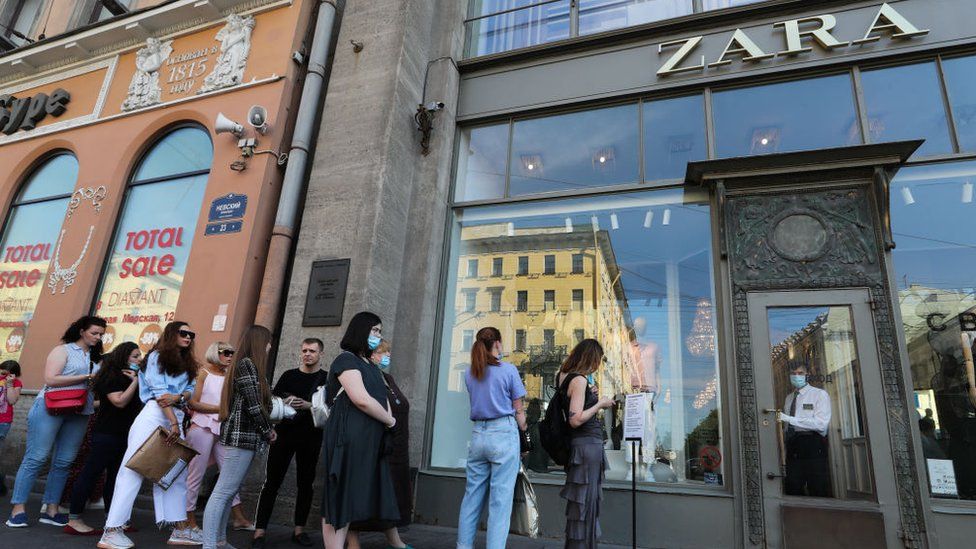 People wait in line outside a Zara store in Nevsky Avenue, St Petersburg
