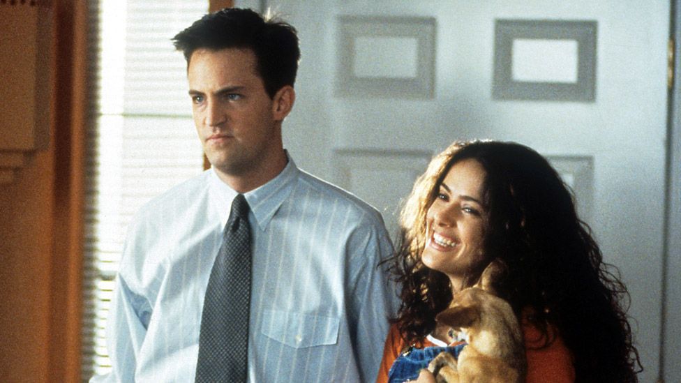Matthew Perry and Salma Hayek enter a home in a scene from the film 'Fools Rush In', 1997