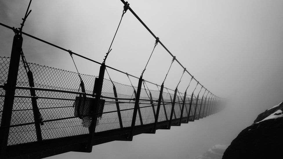 Titlis Cliff Walk in Switzerland floating in the midday cloud