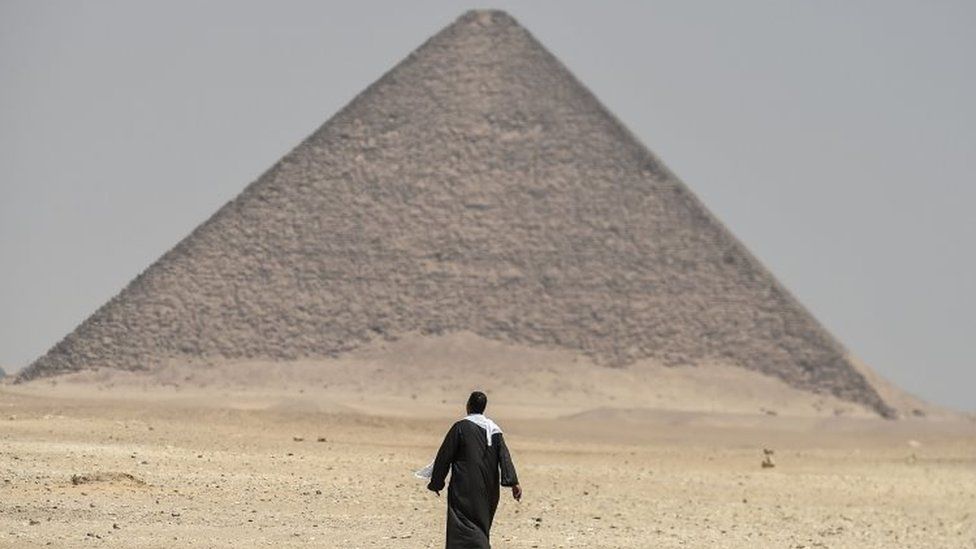 A man walks next to the Red Pyramid at Dahshur. Photo: 13 July 2019