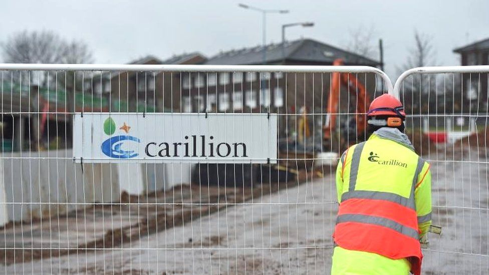 Carillion sign and worker