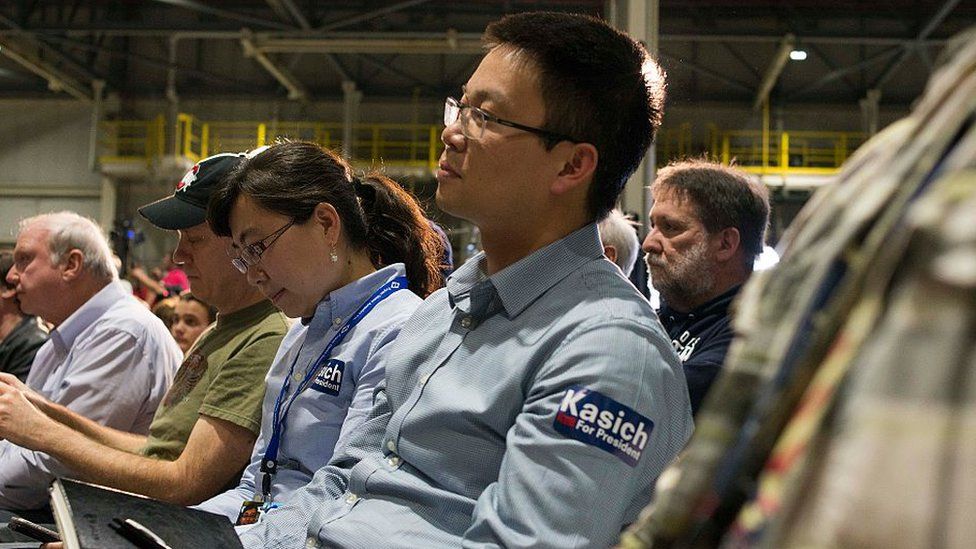 Attendants listen to Ohio Republican Governor and presidential candidate John Kasich speaking at a Campaign Town Hall at Fuyao Glass America Inc. on March 11, 2016 in Moraine, Ohio.