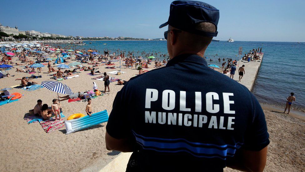 A French police officer patrols the beach in Cannes on 4 August 2016