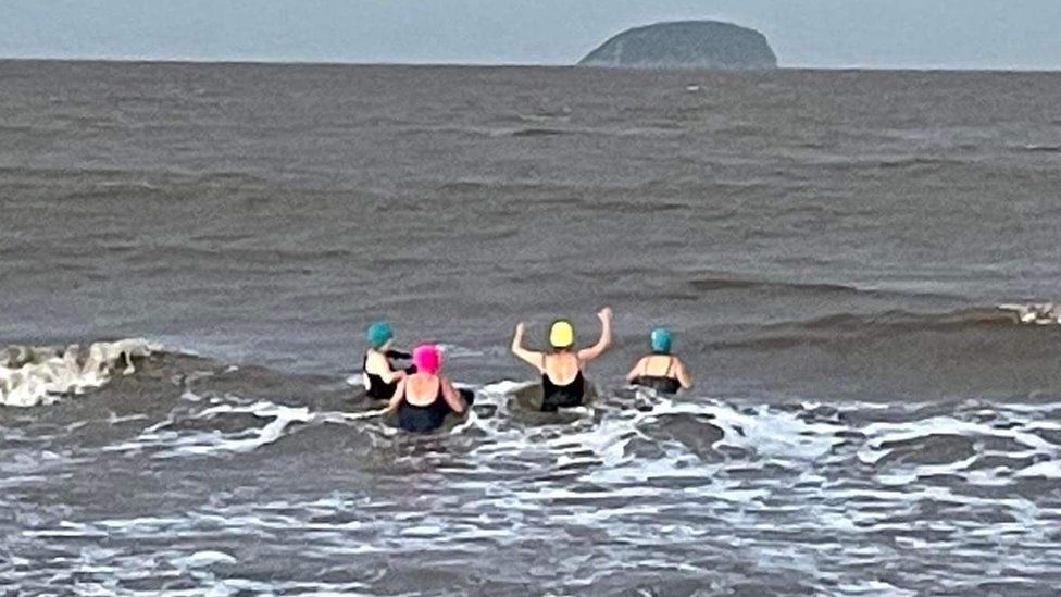 People swimming in the sea at Weston-Super-Mare