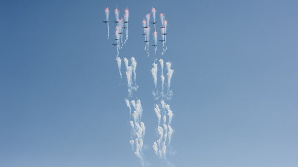 Aircrafts perform a fly-by during a mass rally