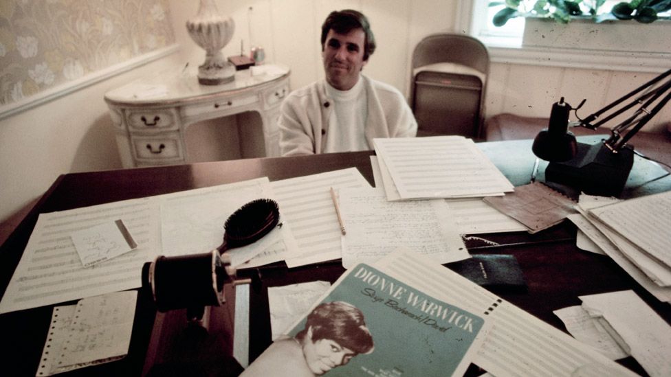 Burt Bacharach at his piano surrounded by musical manuscripts in 1969