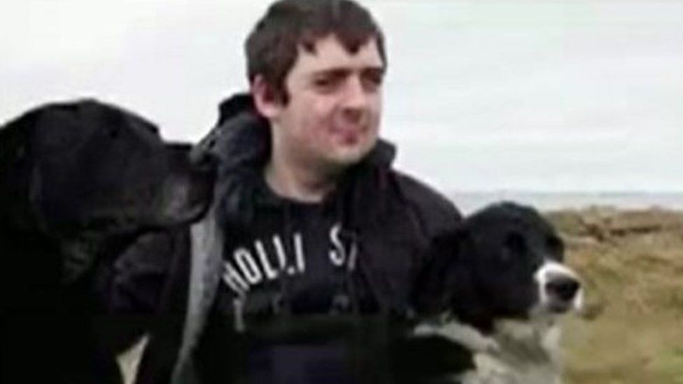 Iwan Caudy with his two dogs on the beach