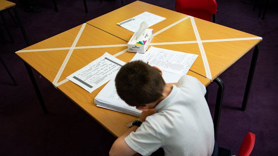 Child sits at school desk