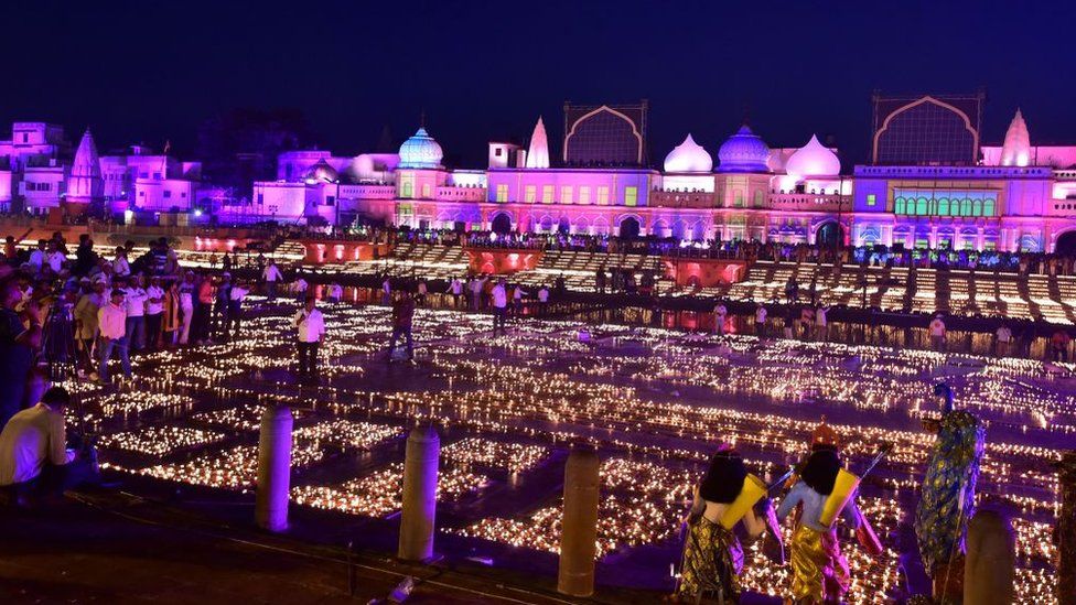 Devotees light earthen lamps on the banks of river Sarayu on the eve of Diwali, the Hindu festival of lights, in Ayodhya on October 23, 2022. (Photo by SANJAY KANOJIA / AFP) (Photo by SANJAY KANOJIA/AFP via Getty Images)