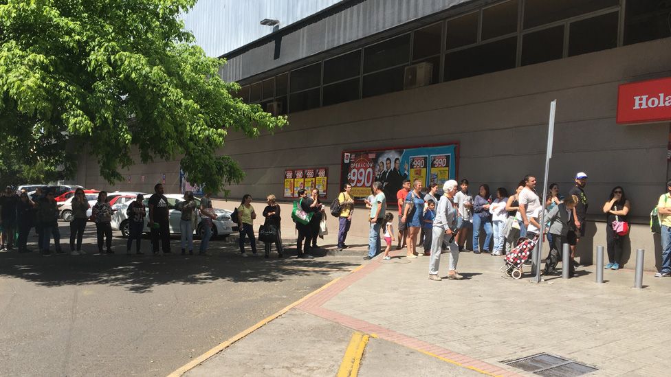 People queue in Santiago