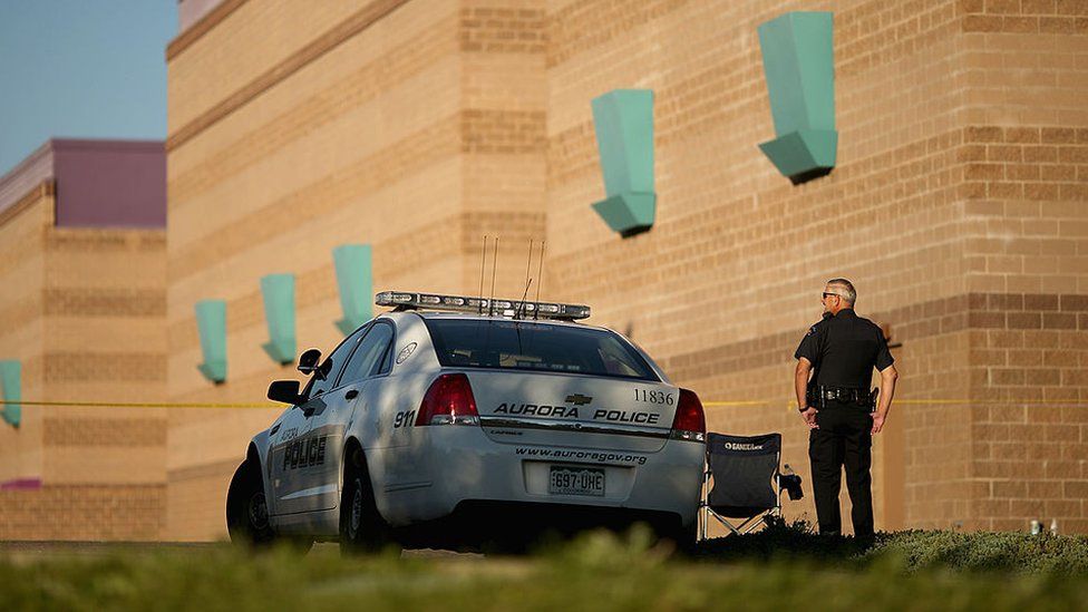 Aurora Police maintains a secure perimeter around the movie theater a day after mass shooting in 2012 in Aurora, Colorado