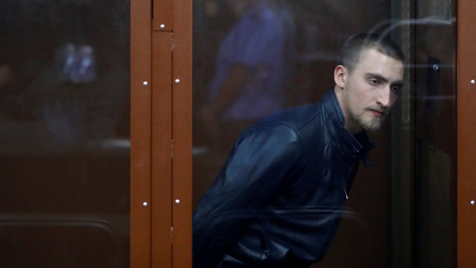 Pavel Ustinov, accused of using violence against an officer of Russia's National Guard during an unauthorised rally to demand free elections, attends a court hearing in Moscow.