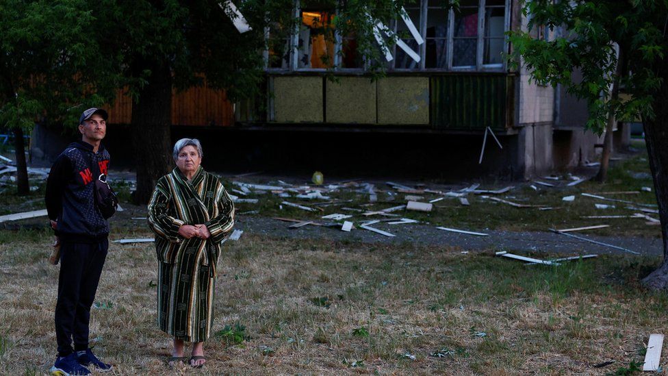 Residents outside a Kyiv apartment building damaged by a Russian missile strike