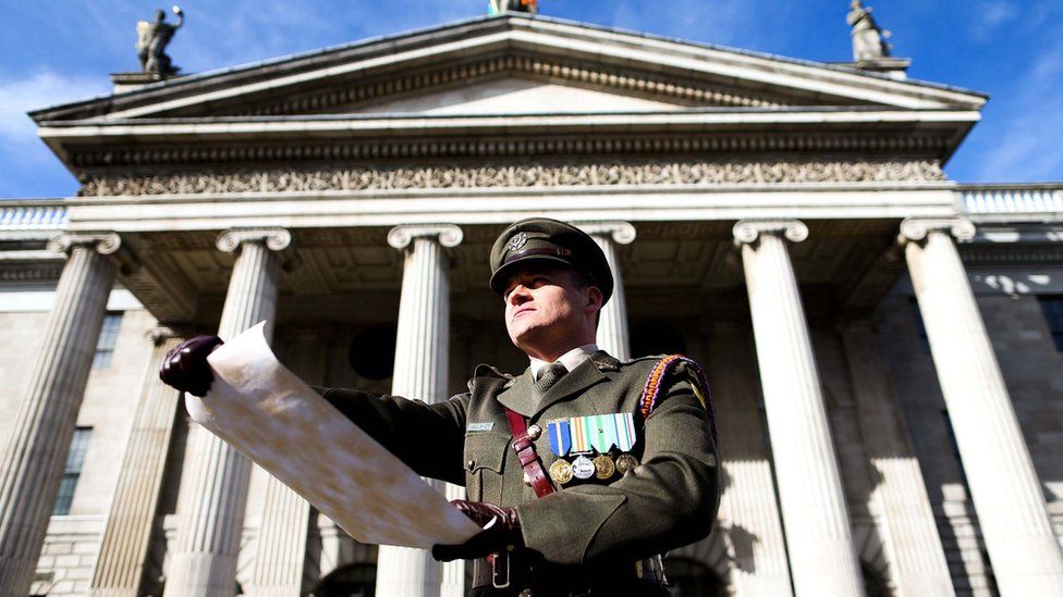 A member of the Irish Defence Forces read the Proclamation of Independence outside the GPO