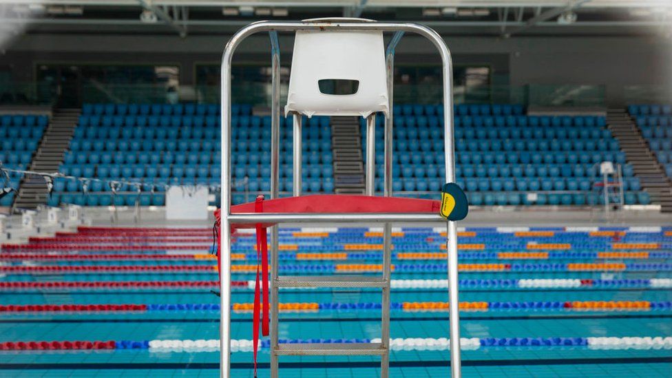 An empty lifeguard chair at the empty Cardiff International swimming pool