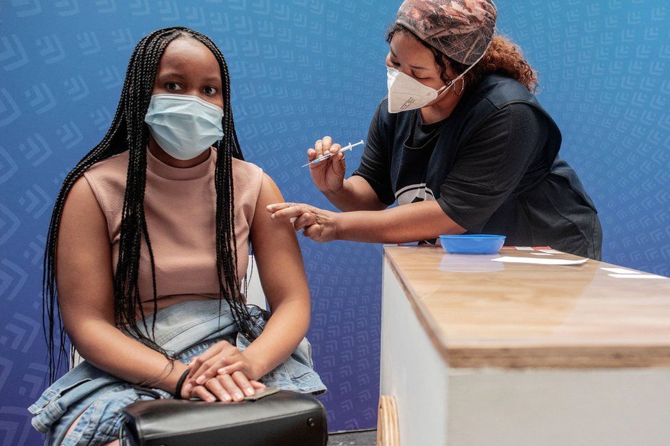 A woman receives a dose of the Pfizer-BioNTech vaccine against Covid-19 in Sandton, Johannesburg, on 15 December 2021