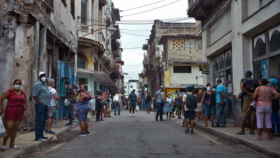 People queue to buy food in Havana on 2 February