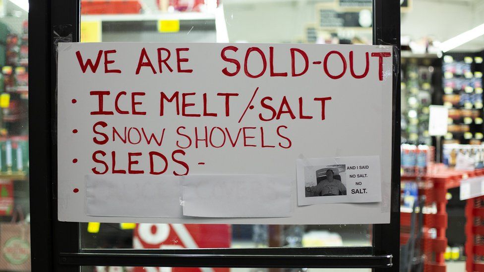 A sign says a shop is sold out of salt, snow shovels and sleds