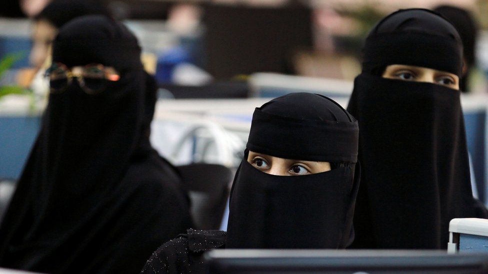 Three women wearing a niqab