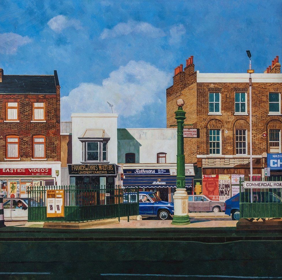 A painting of a street of shops in London by Doreen Fletcher