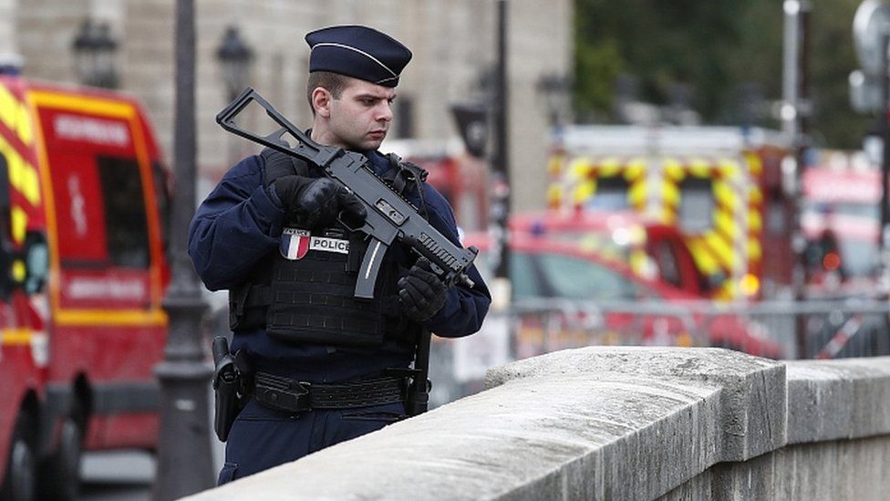 Police officer near the scene of the stabbings in Paris