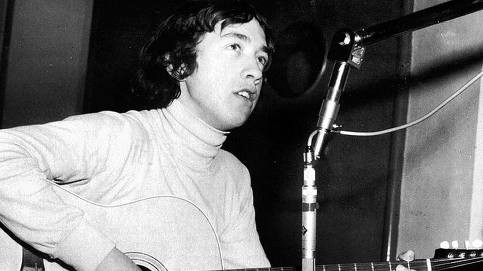 George Young playing the guitar