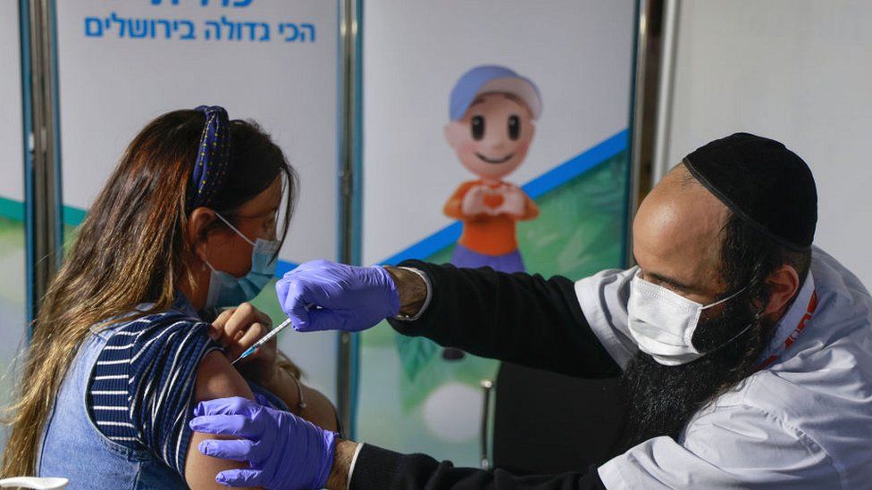 Woman receiving vaccine in Jerusalem.