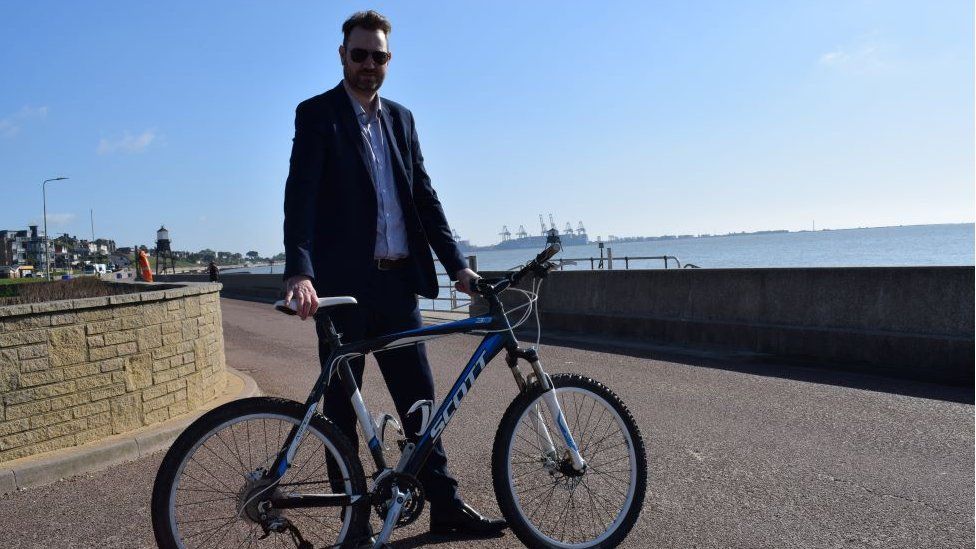 Councillor Alex Porter on Dovercourt promenade with bike