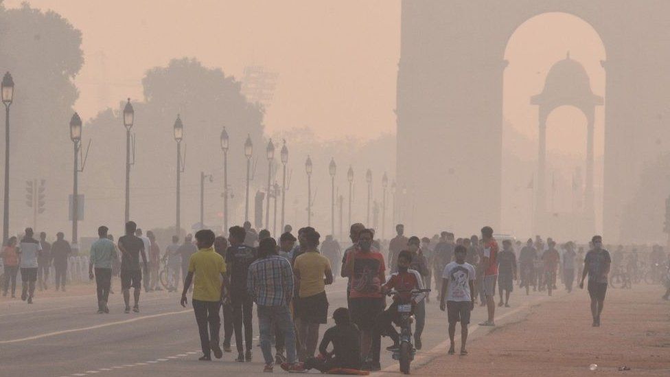 Visitors at a mist covered India Gate, on October 18, 2020 in New Delhi, India
