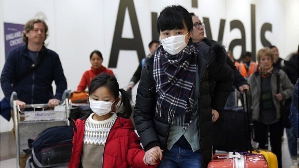 Passengers arrive wearing a mask at Terminal 4, Heathrow Airport, London, Britain, 22 January 2020.