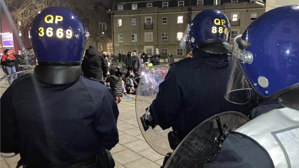 Riot officers in front of protesters