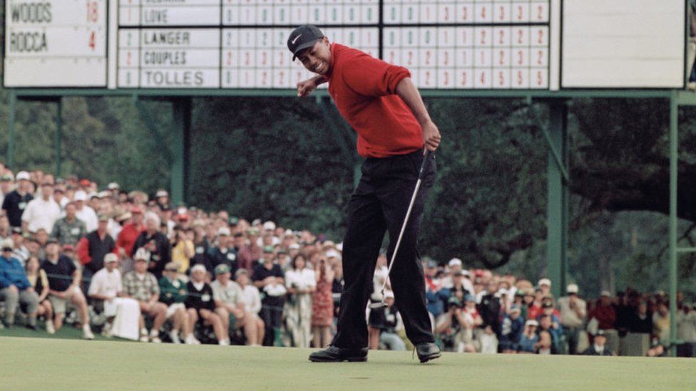 Tiger Woods of the United States celebrates after sinking a 4 feet putt to win the US Masters Golf Tournament with a record low score of 18 under par 13 April 1997 at the Augusta National Golf Club