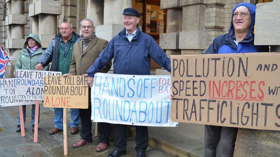 People with placards protesting outside Grimsby Town Hall