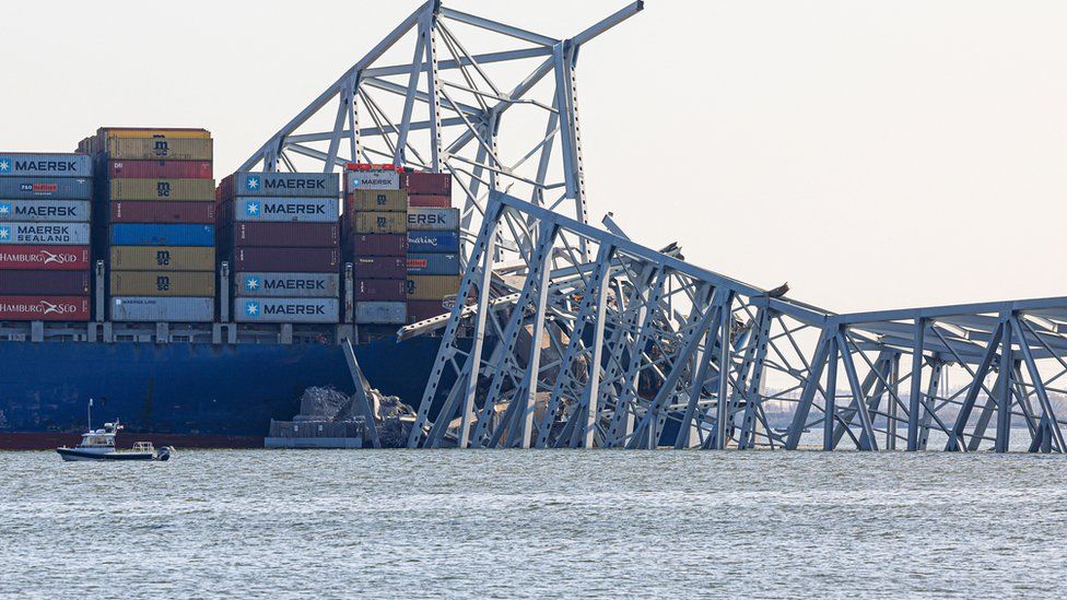 The wreckage of the Francis Scott Key Bridge lies across the Dali cargo ship in Baltimore