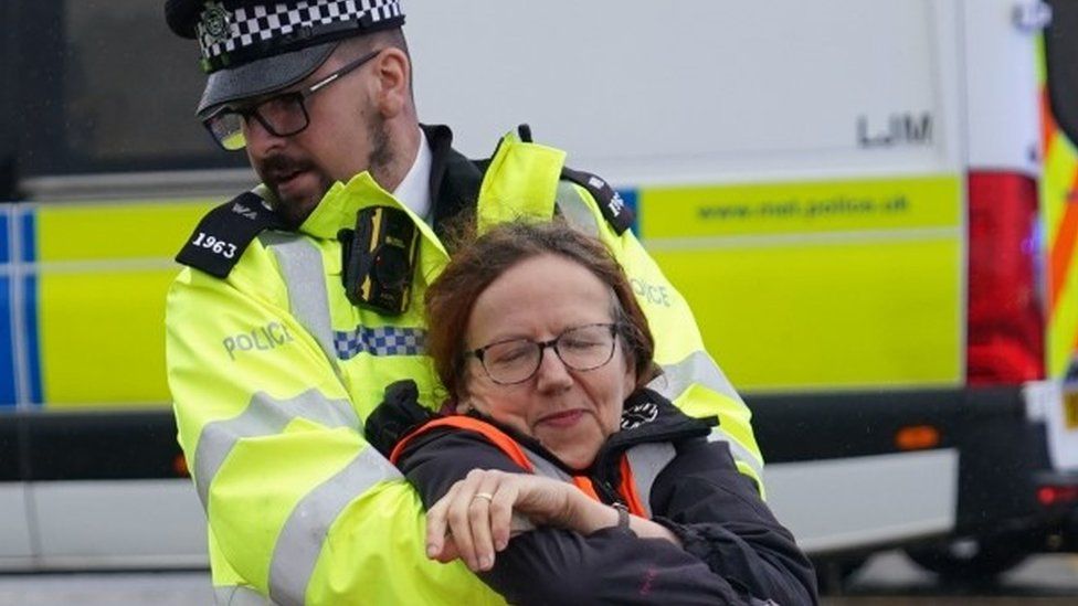 Police officer arrests a protester